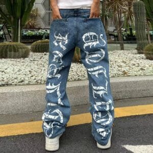 Style décontracté : Jean denim ample avec graphisme audacieux dans un cadre verdoyant.